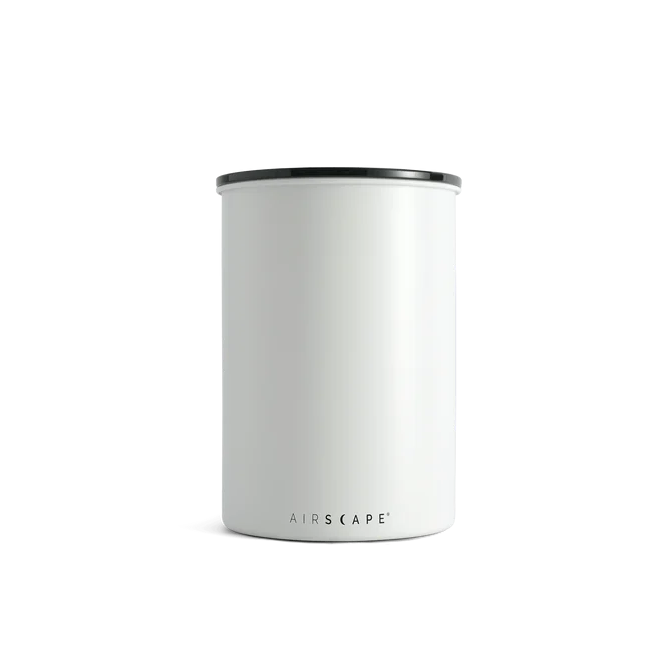 White cylindrical container with black rim on a white background